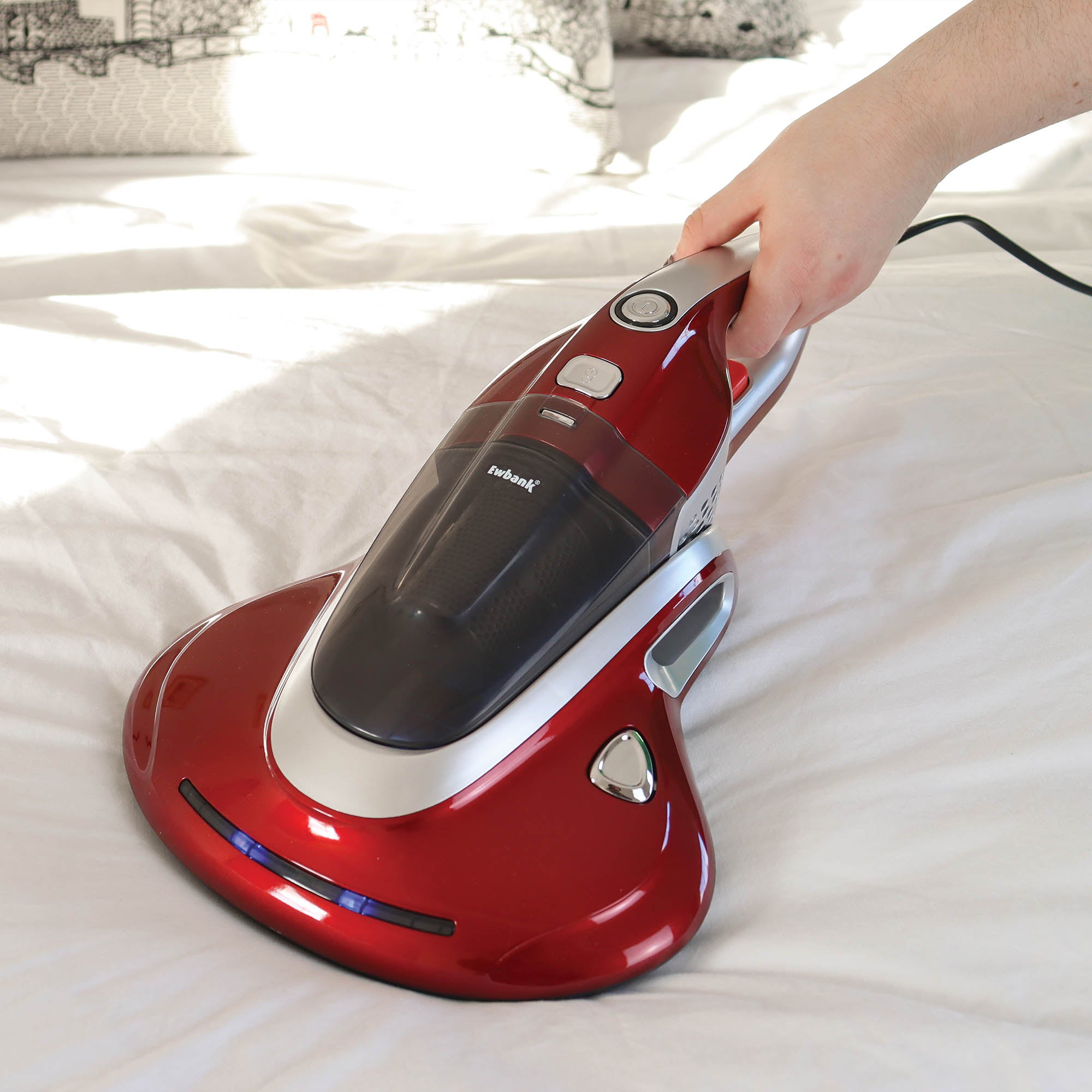Red and silver handheld vacuum cleaner on a white surface