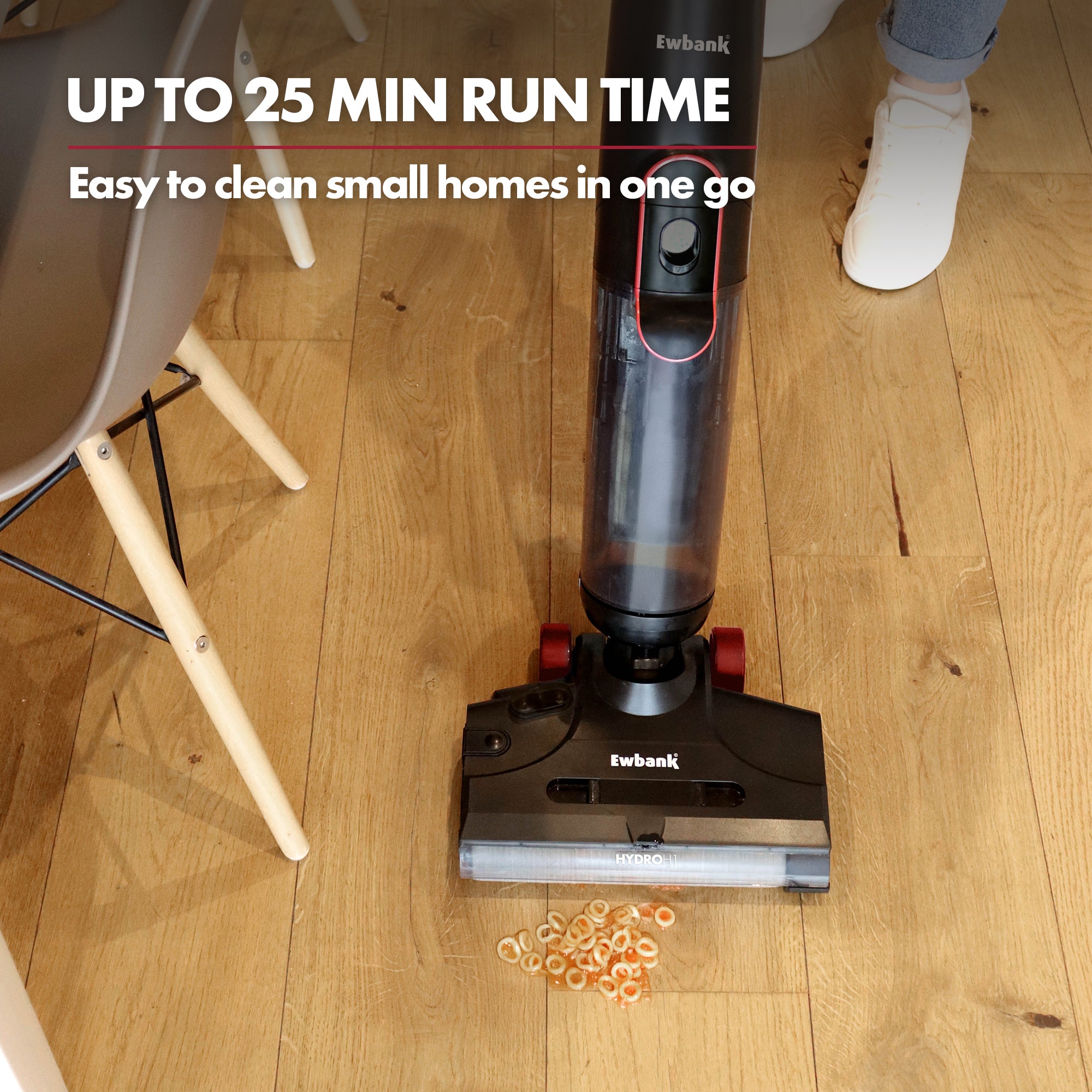 The HYDROH1 Cordless Hard Floor Cleaner, a 2-in-1 Wet & Dry Vacuum, is cleaning cereal from a wooden floor by a chair. Text above reads: UP TO 25 MIN RUN TIME and easily clean small homes in one go.