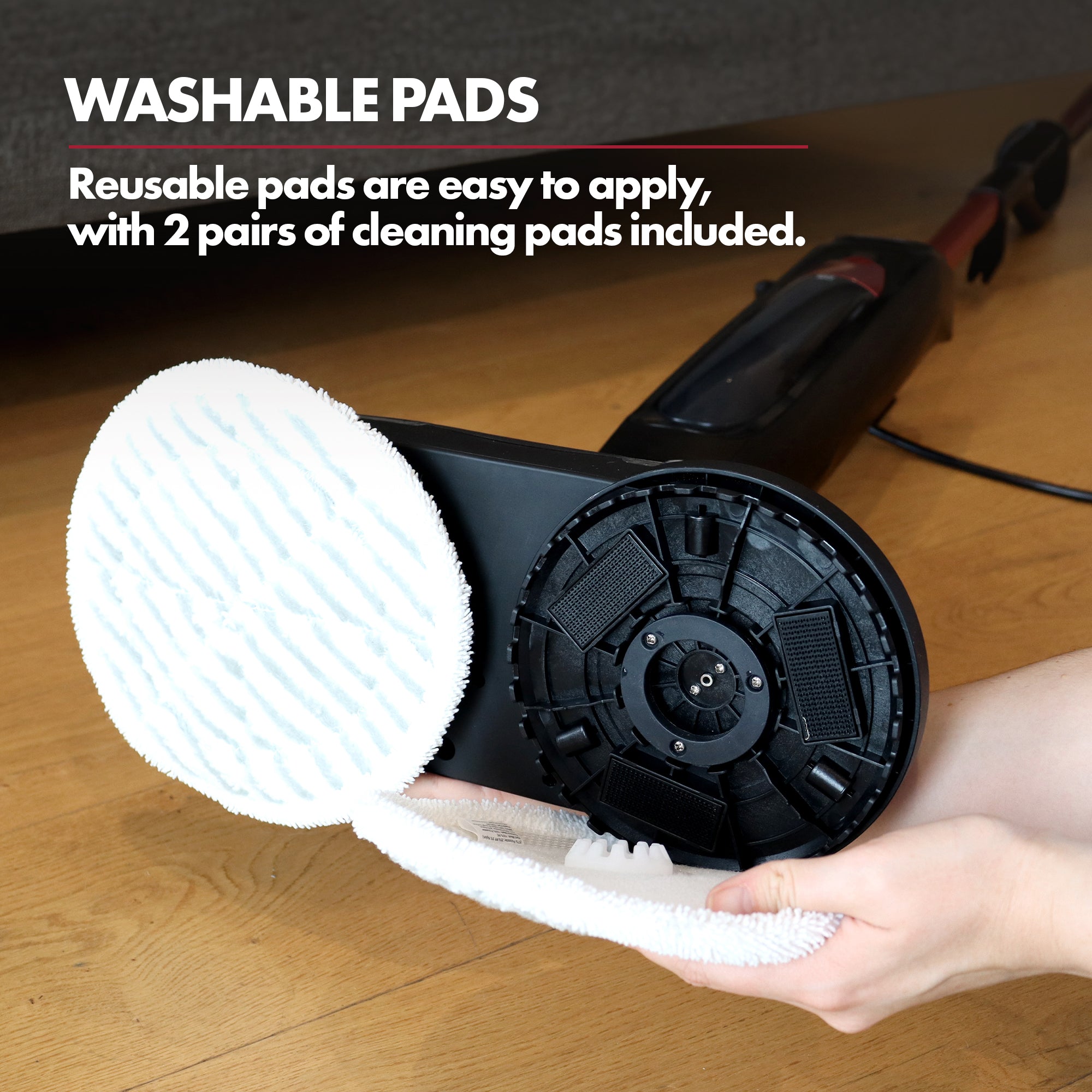 A person attaches a white cleaning pad to the Ewbank EWST04079 HYDROS2 Steam and Spin Mop. The text “WASHABLE PADS” notes that 2 pairs of reusable pads are included for effective hard floor cleaning.