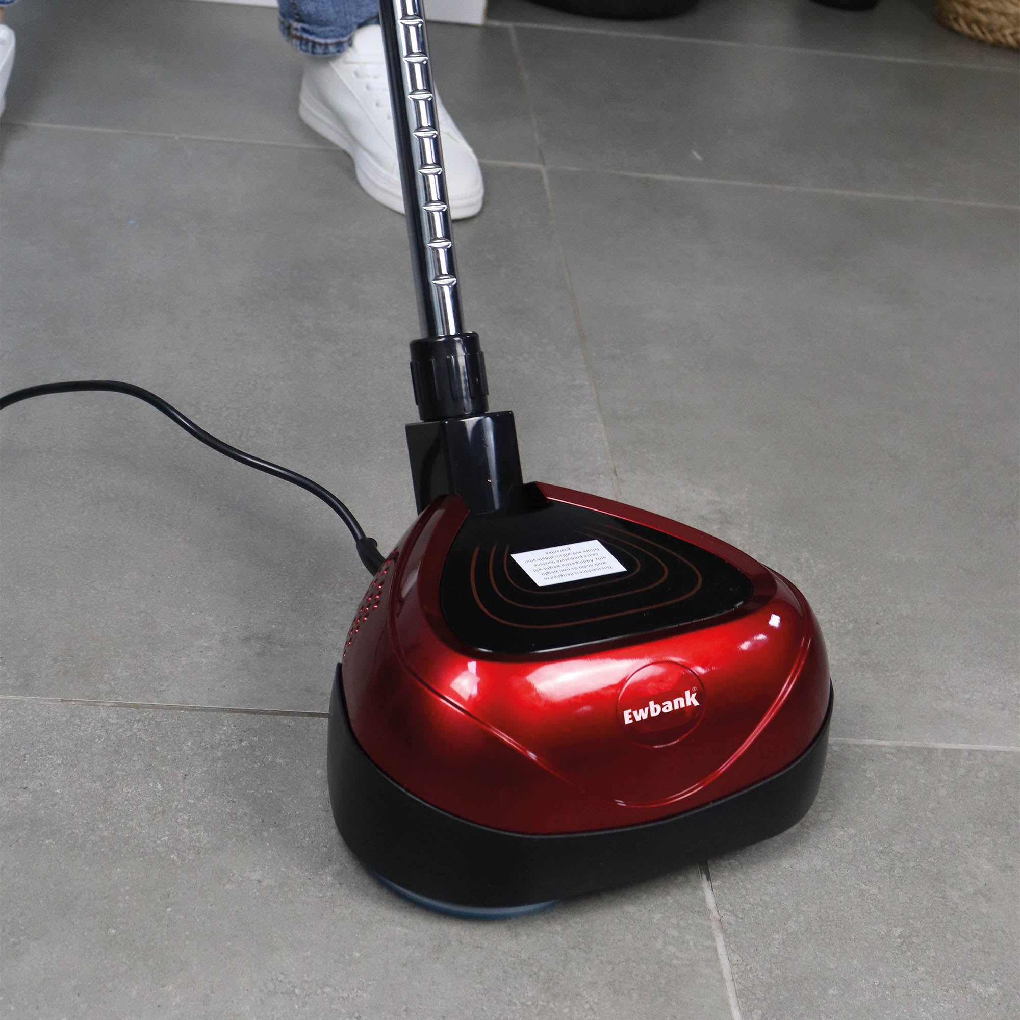 A red EP170 Multi Use 3-in-1 Floor Cleaner & Polisher on gray tiles, plugged in and being used by someone in white shoes—a reliable tool for spotless hard floors.