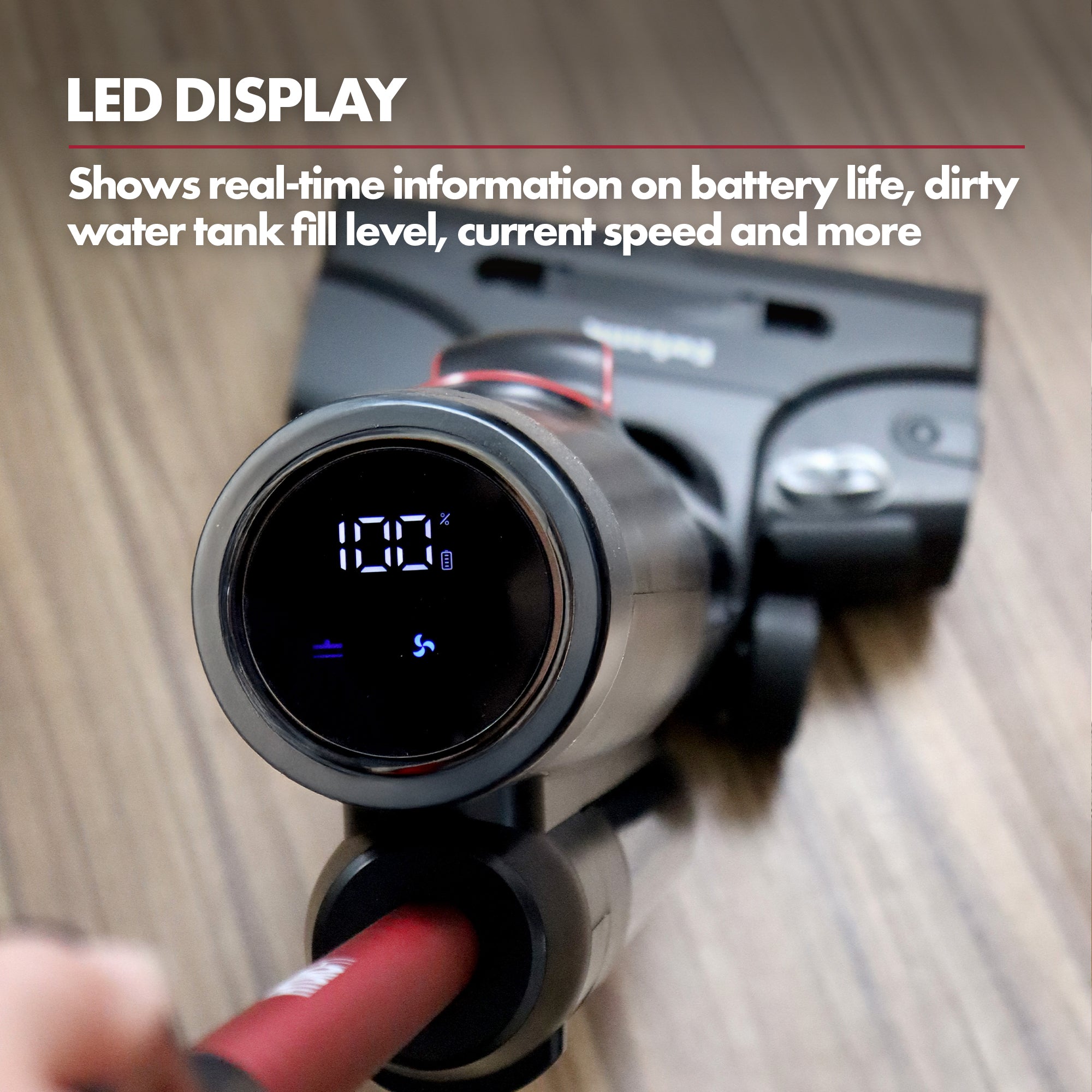 A close-up shows the HYDROH1 Cordless Hard Floor Cleaner's circular LED display at 100% battery. Mounted on the handle, this 2-in-1 wet & dry vacuum stands on a wooden floor, with text highlighting its real-time display features.